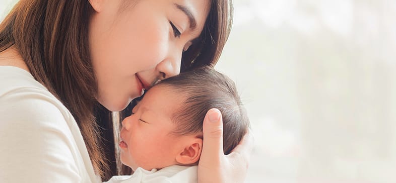 Woman and infant snuggling