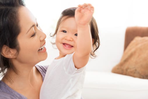 Smiling mother with happy baby