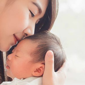 Woman and infant snuggling