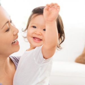 Smiling mother with happy baby